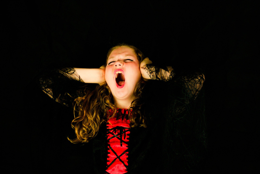 girl holding her ears closed